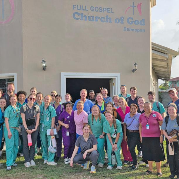 ETSU student pharmacists and faculty posed with community people in Belize outside the Full Gospel Church of God Belmopan