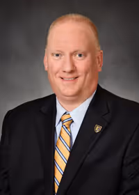 A headshot of John King