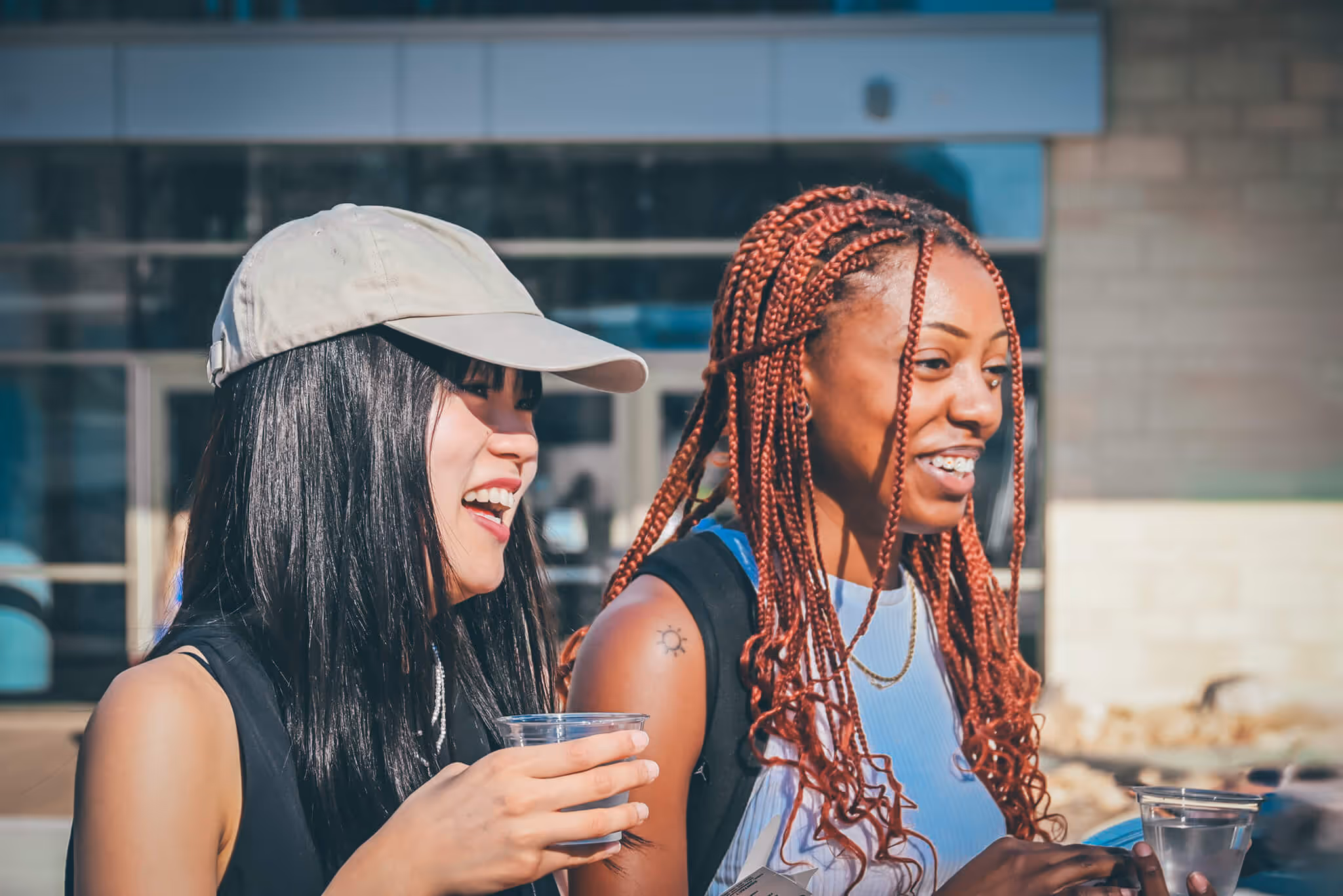 Two students looking in the distance and smiling.