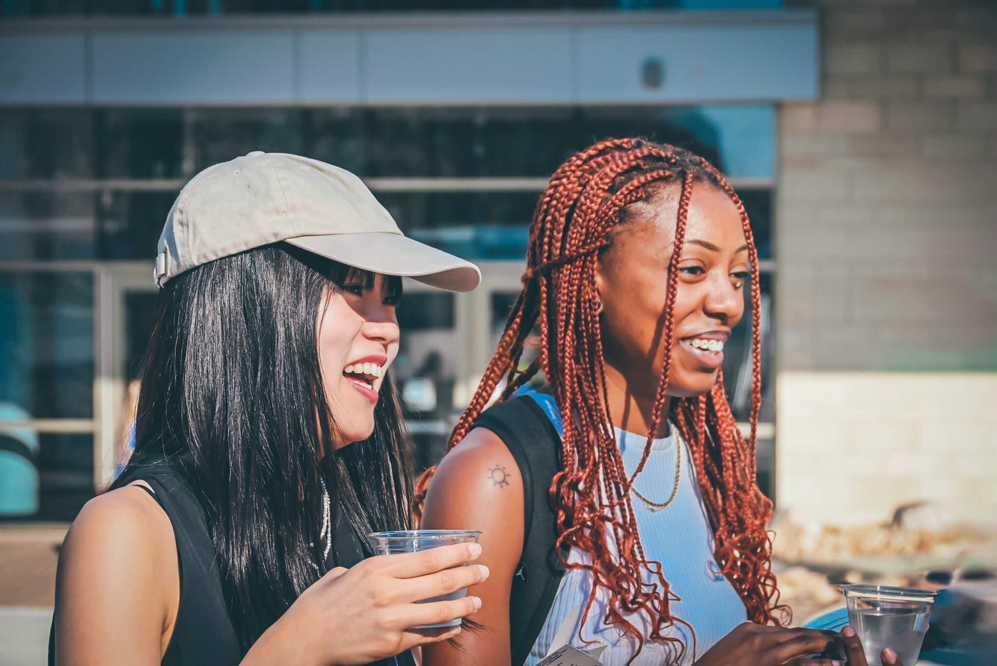 Two students looking in the distance and smiling. 