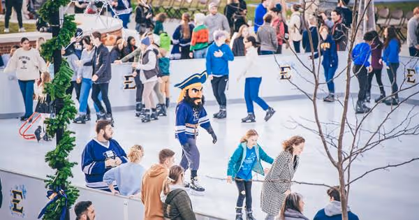Bucky skates with other skaters on the rink.
