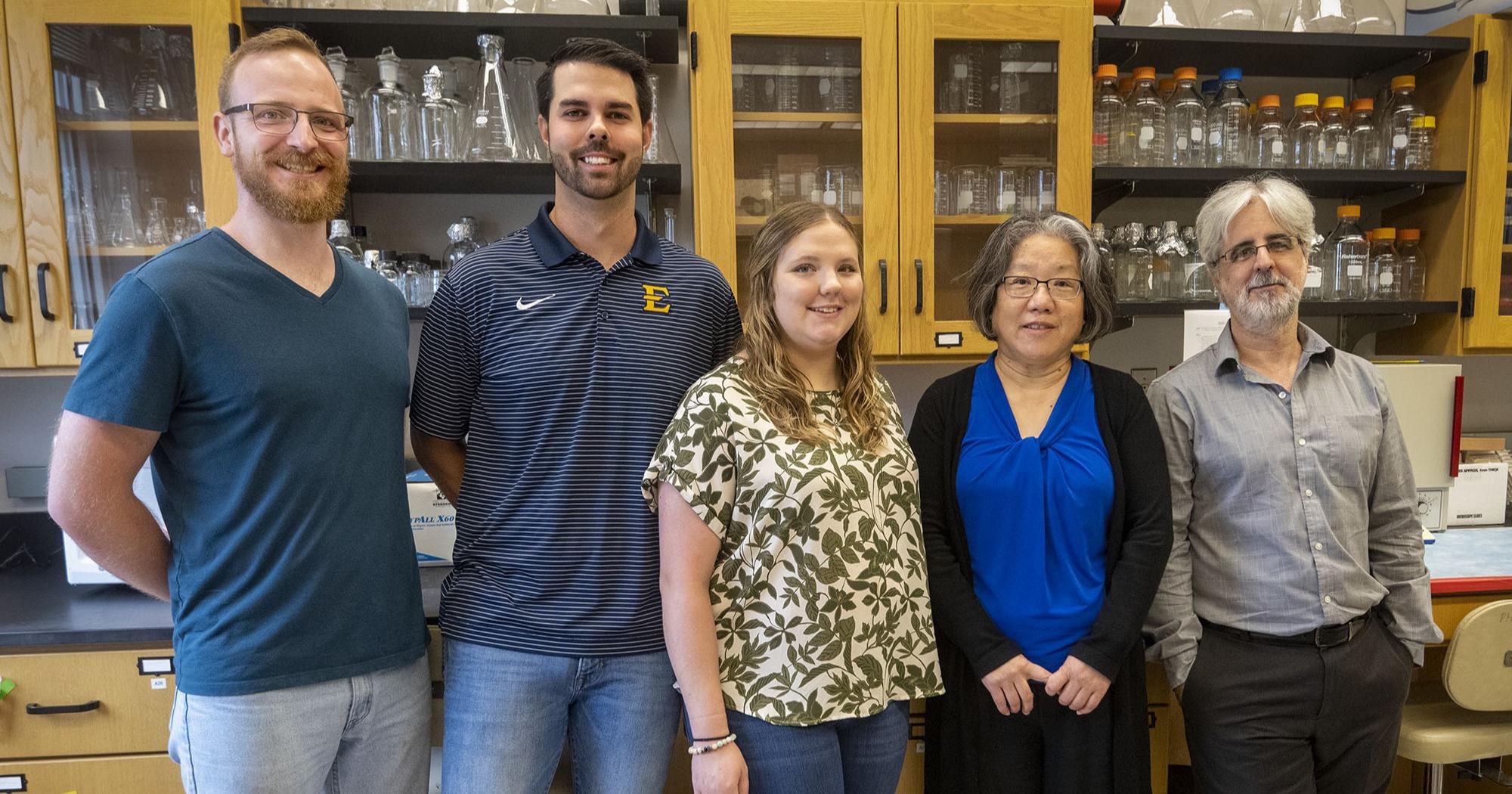 Jia poses for a photo with her students and collaborators.