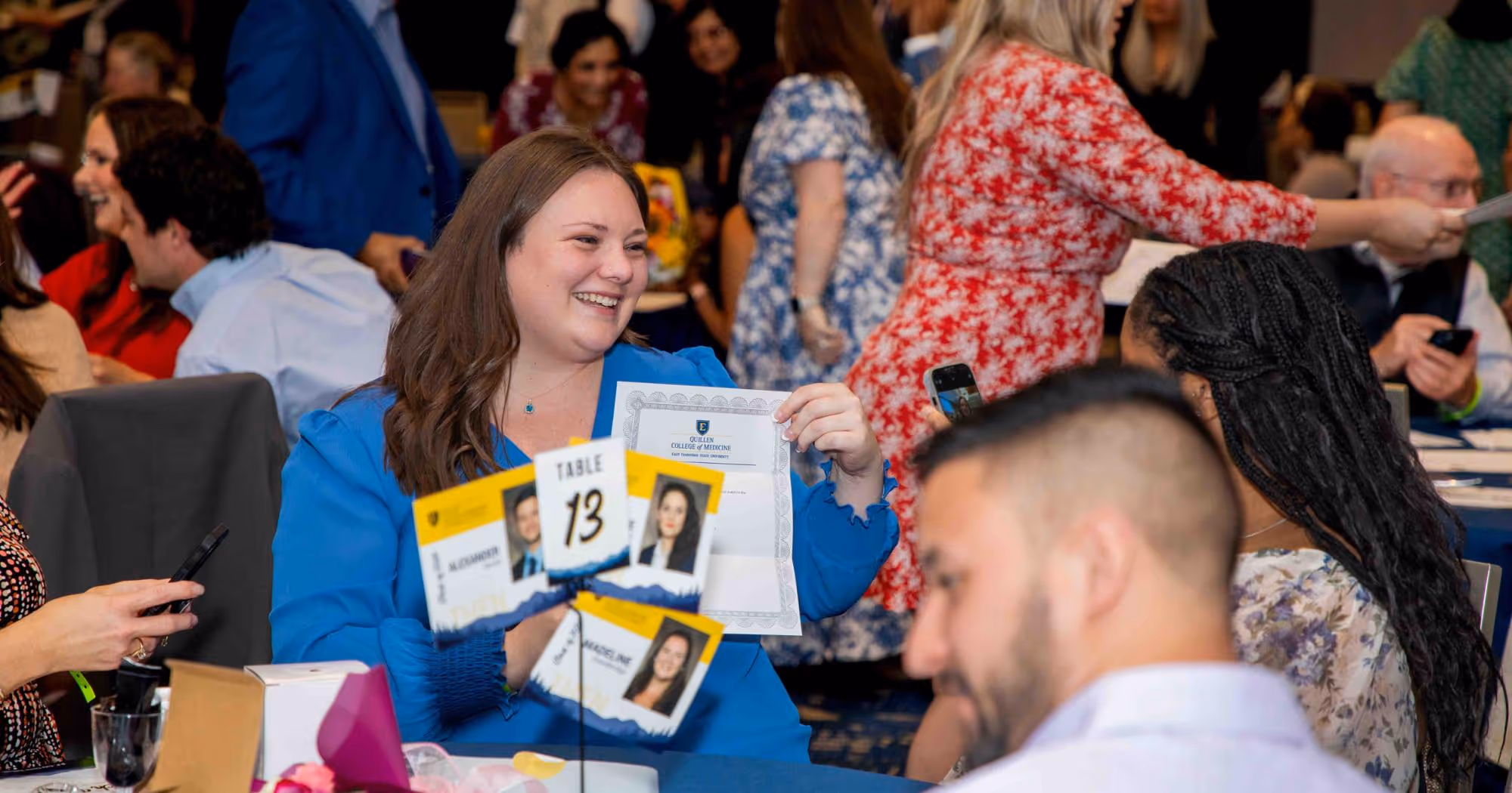 A Quillen College of Medicine student smiles after opening their evelope revealing where they'll spend their residency.