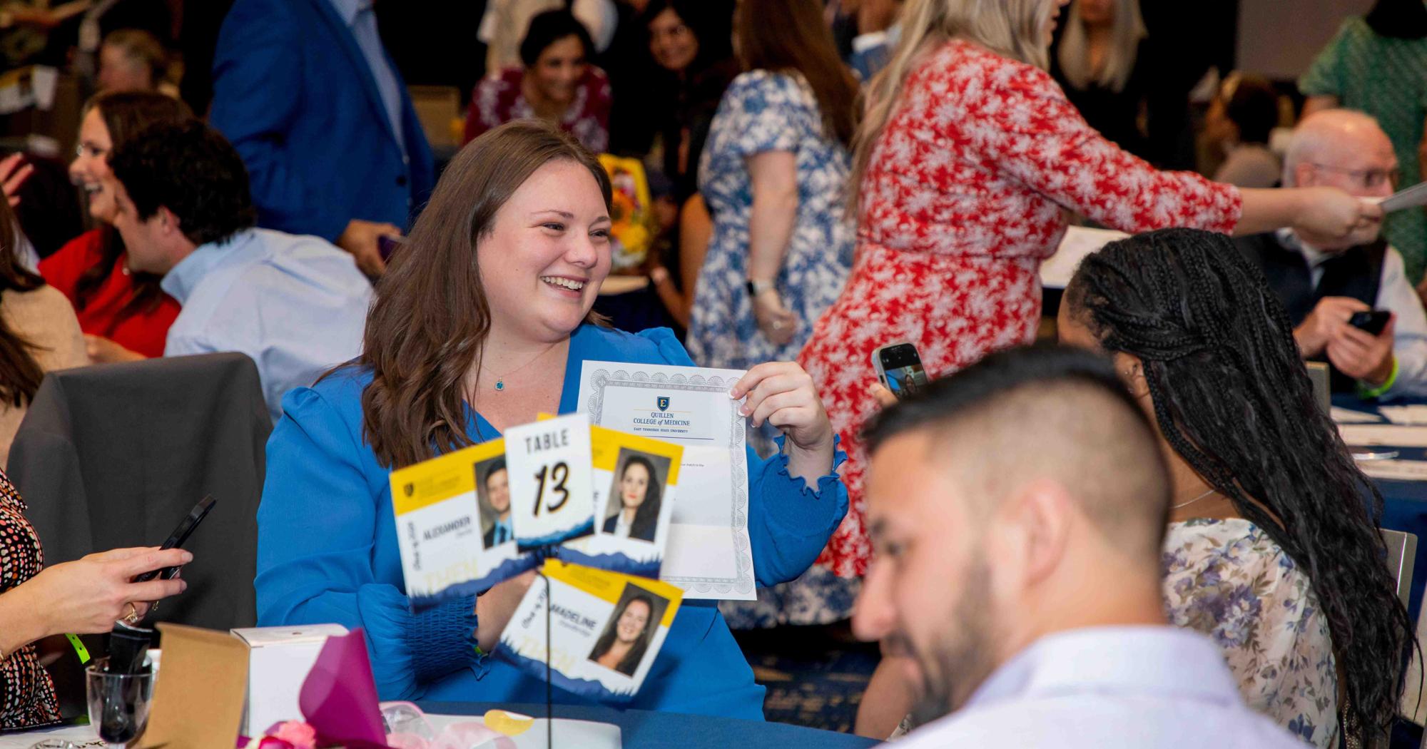 A Quillen College of Medicine student smiles after opening their evelope revealing where they'll spend their residency.
