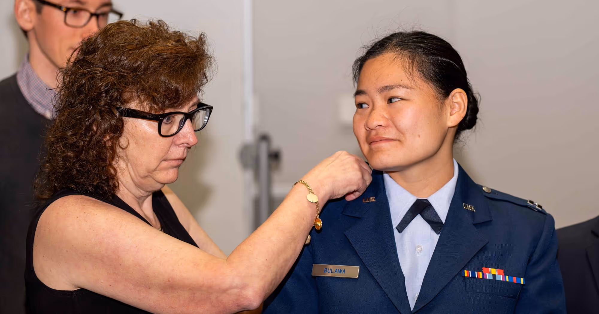 A Quillen College of Medicine student receives their rank pins during the college's military promotion ceremony.