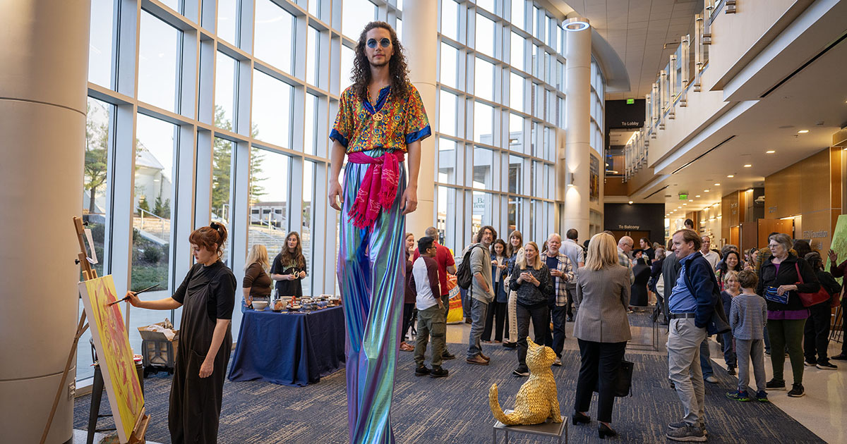Visitors explore student art installations and live painting in the Tindall Lobby during the ETSU Mary B. Martin School of the Arts Showcase at the Martin Center for the Arts.