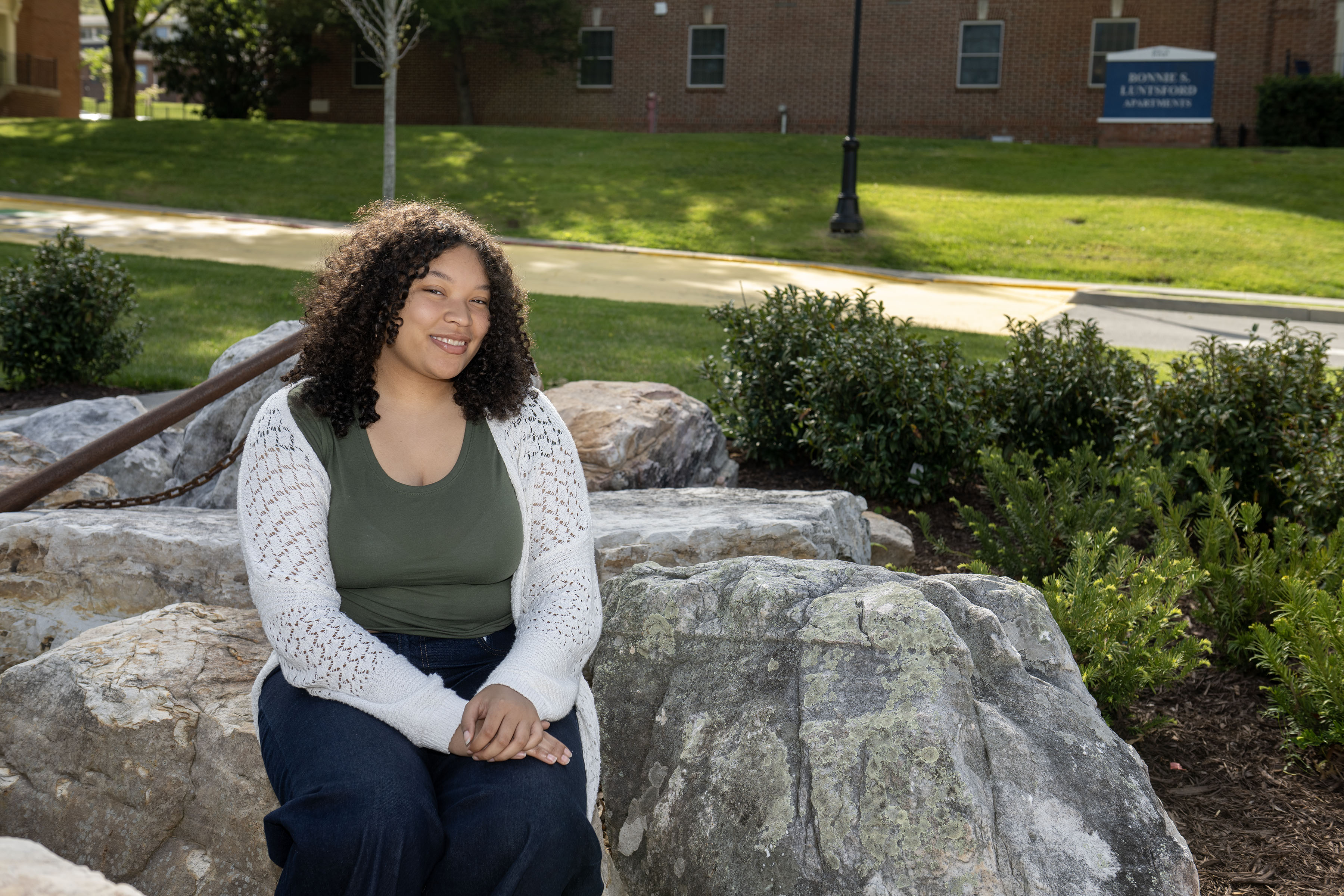 Nia sits on the rocks surrounding the Bucky statue.