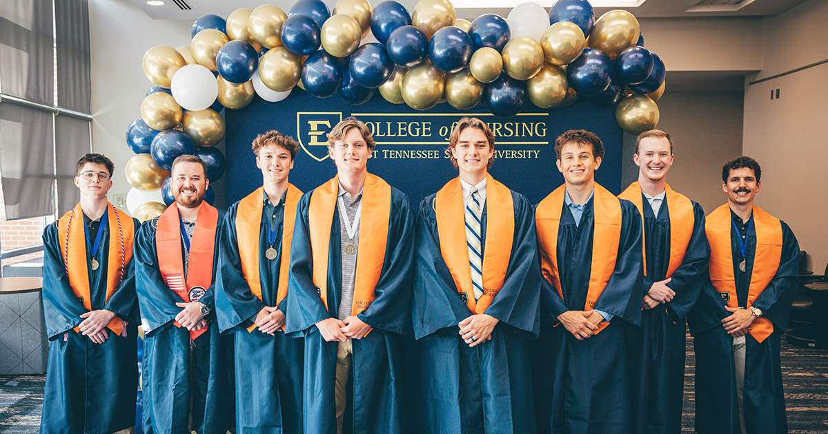 A group of male graduates from the Spring 2026 Class of ETSU's College of Nursing pose for photos