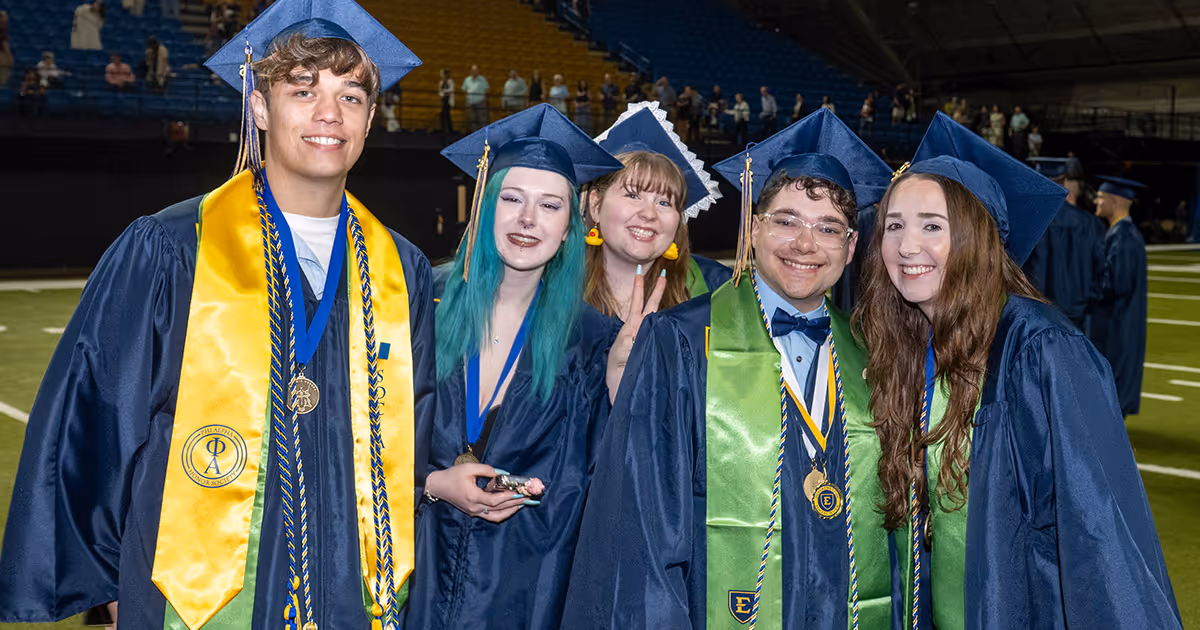 A group of graduates pose for a photo