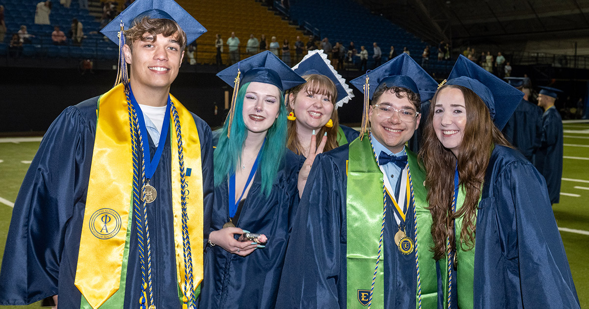 A group of graduates pose for a photo