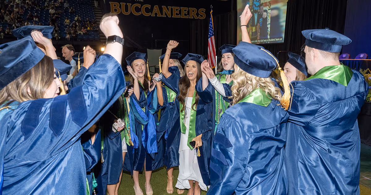 A group of graduates cheer