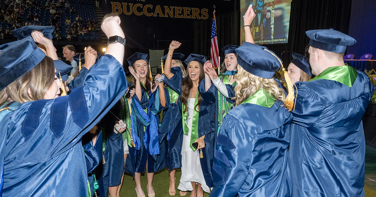 A group of graduates cheer
