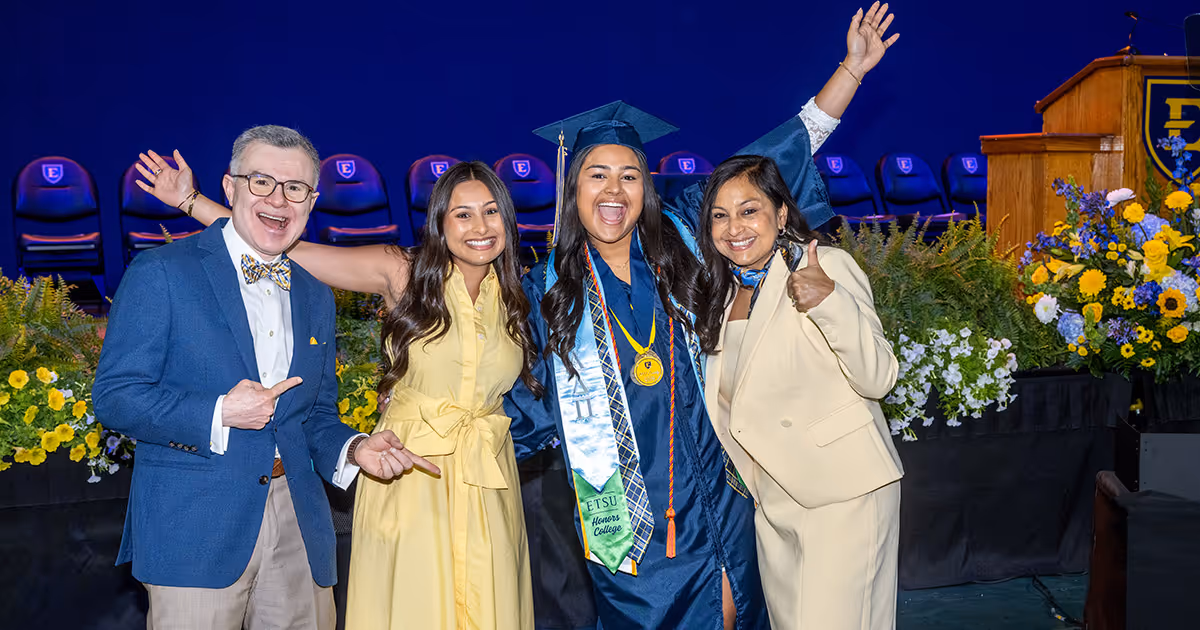 A graduate celebrates with her family