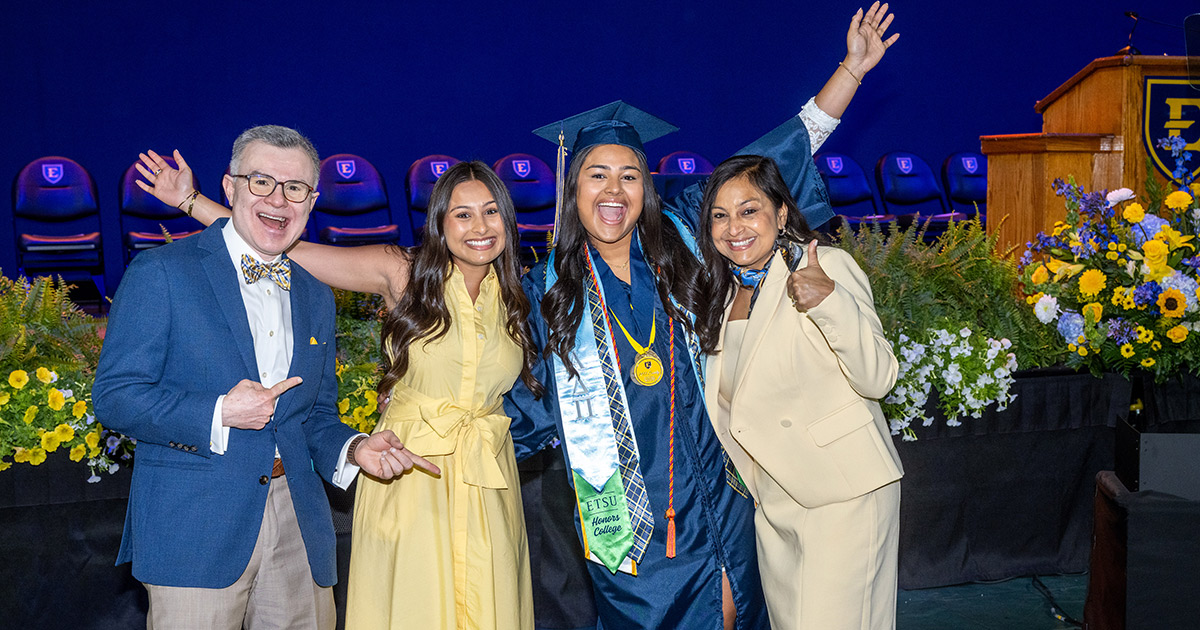 A graduate celebrates with her family