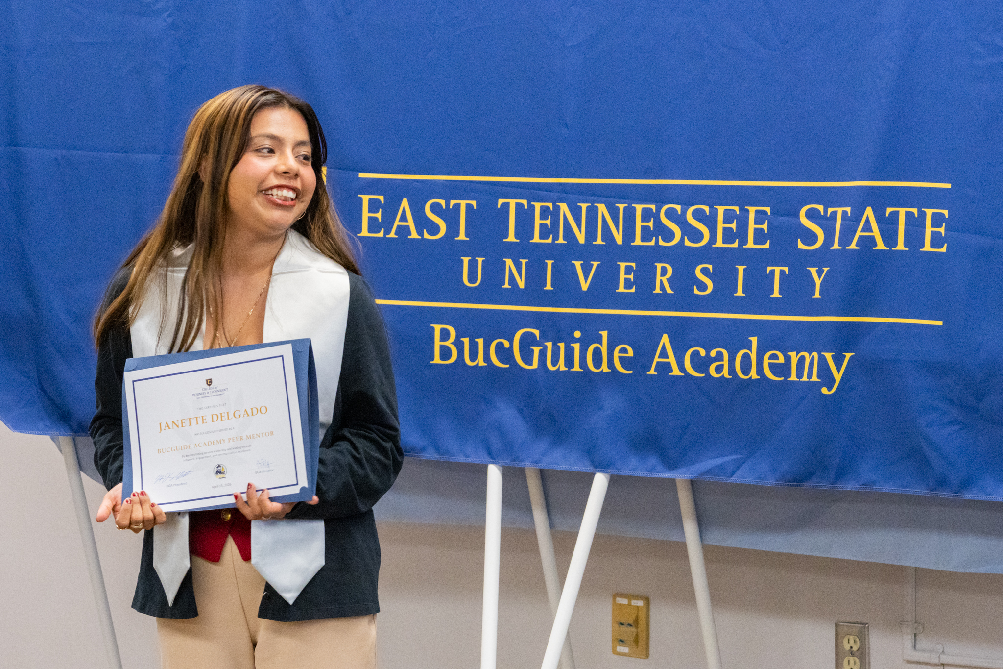 ETSU CBAT student Janette Delgado smiles with her BucGuide Academy diploma.