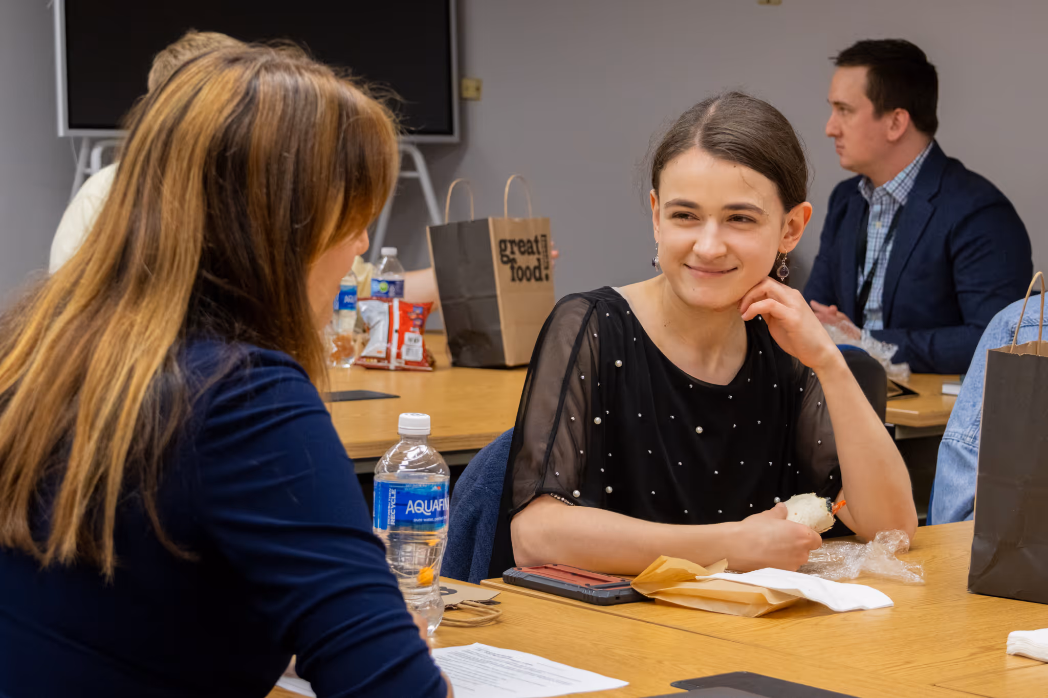 An ETSU CBAT student smiles as they talk with faculty member Elif Demiral.