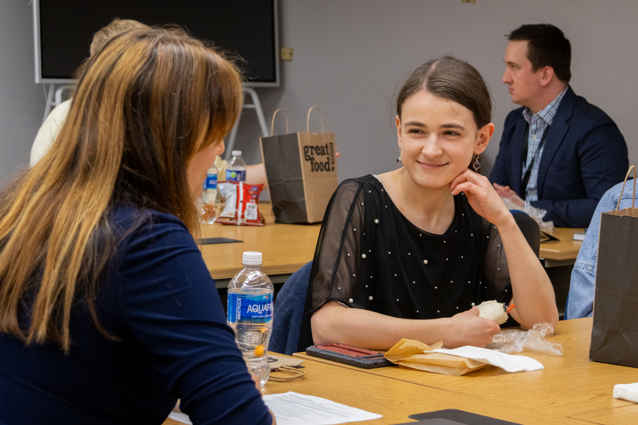 An ETSU CBAT student smiles as they talk with faculty member Elif Demiral.