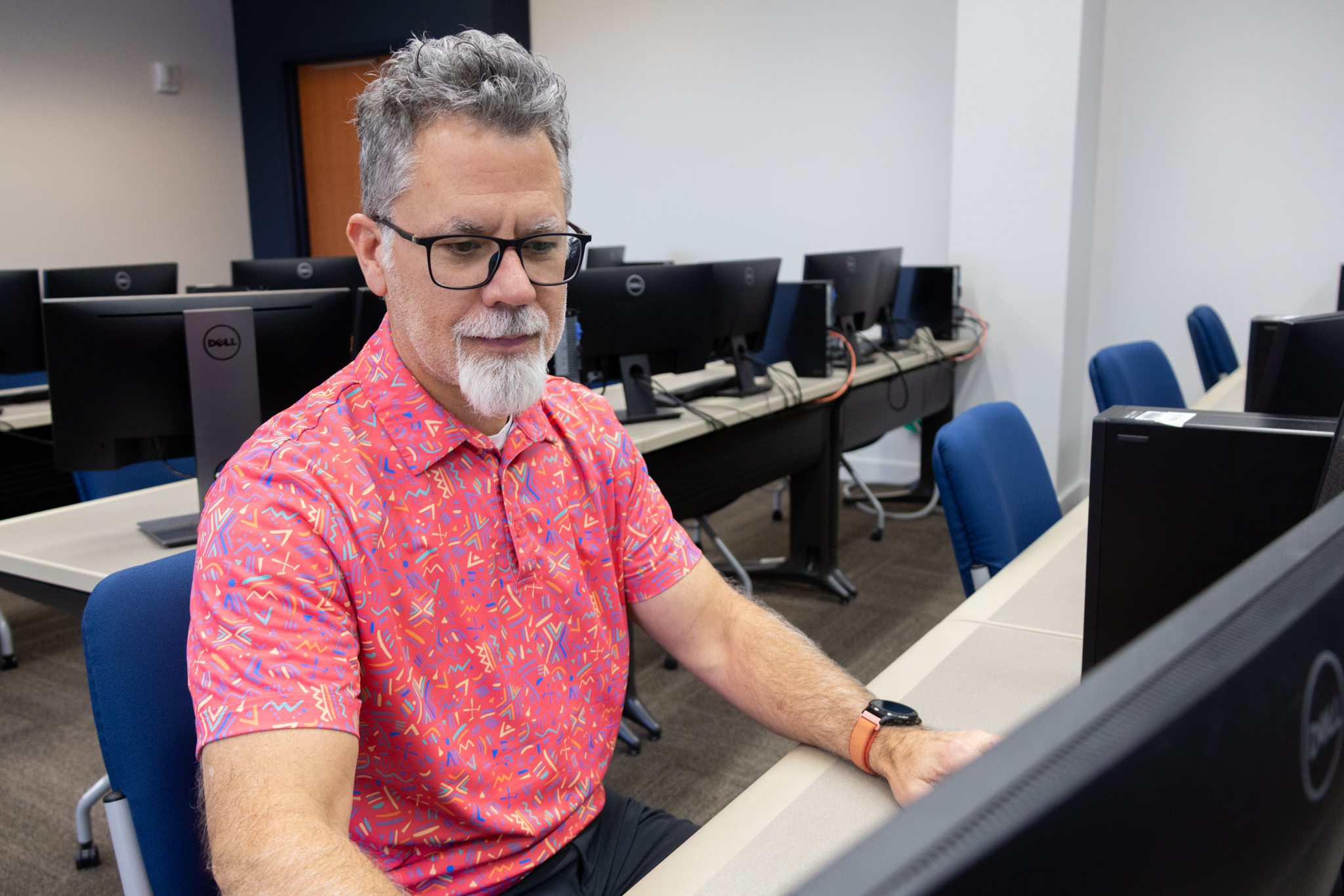 Dr. Michael Lehrfeld, associate professor in the Department of Computing and director of the Cybersecurity Innovation and Outreach Center, types on a computer in a lab.