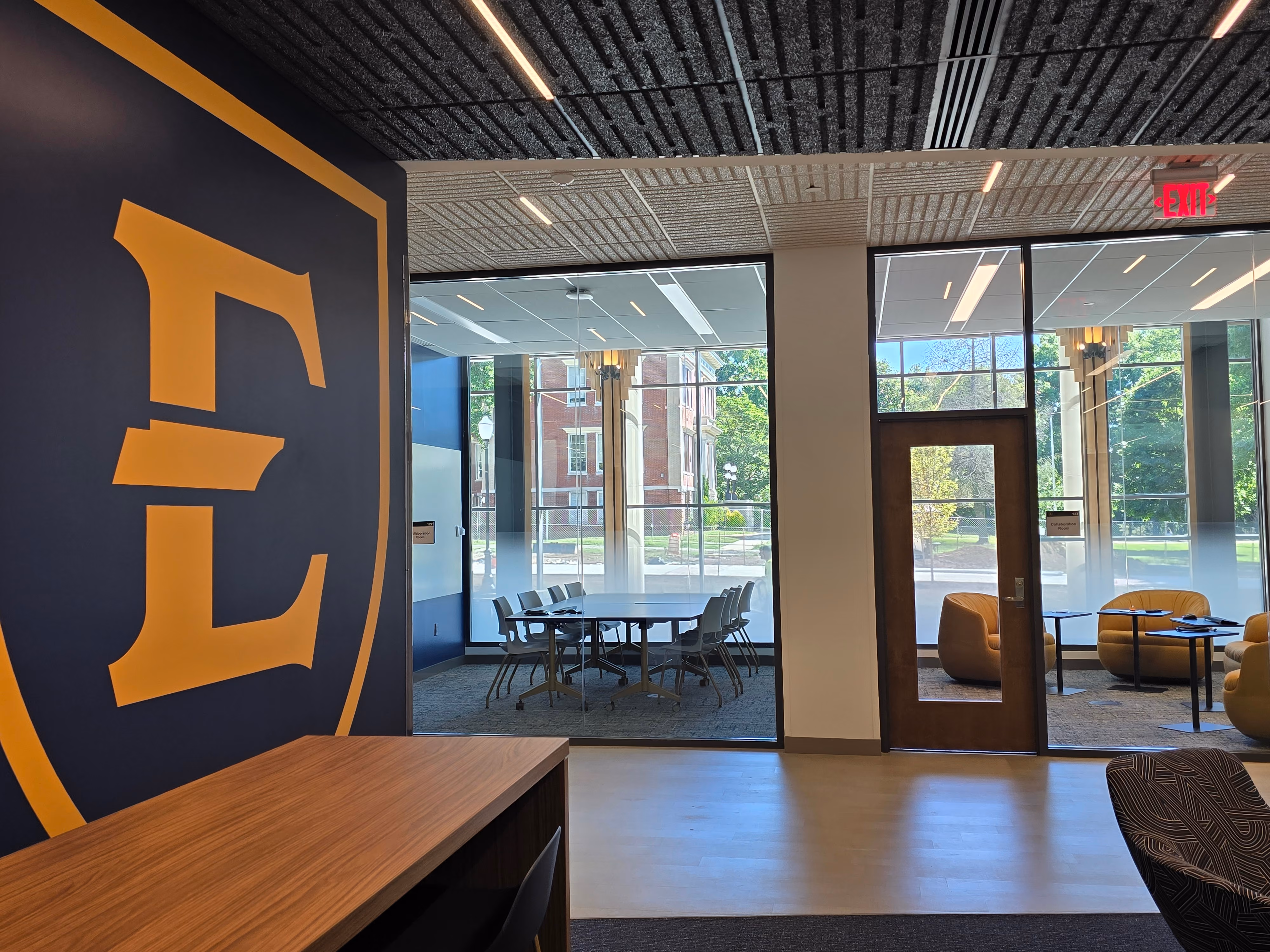A shield E on the wall in the new Academic Building.