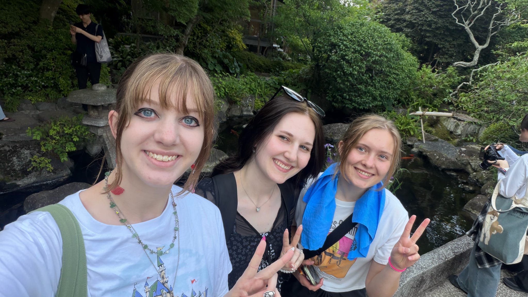 Three ETSU students smile and pose outside during their Japan trip.