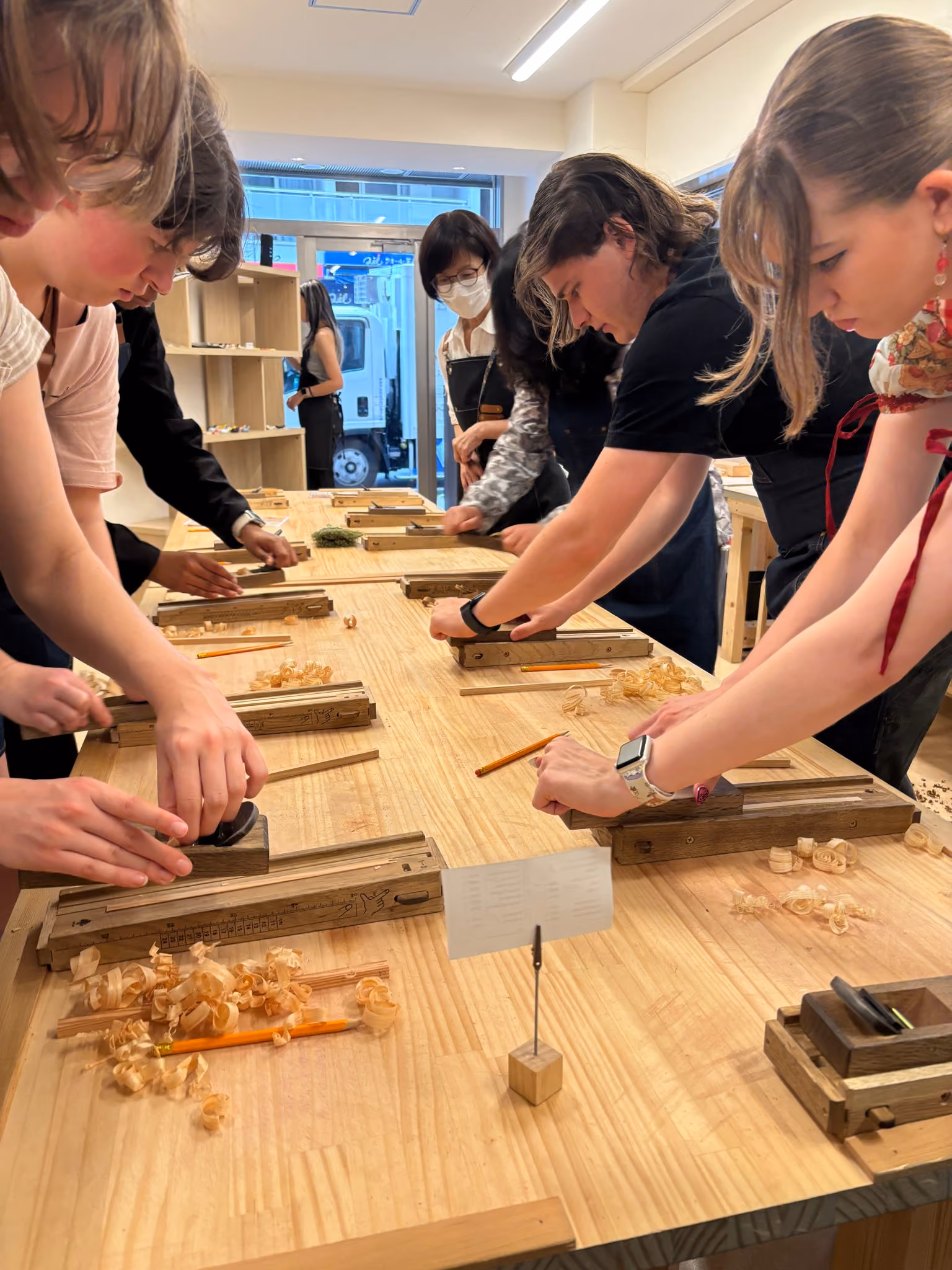 ETSU CBAT and CAS students practice a form of woodworking during the Japan trip.