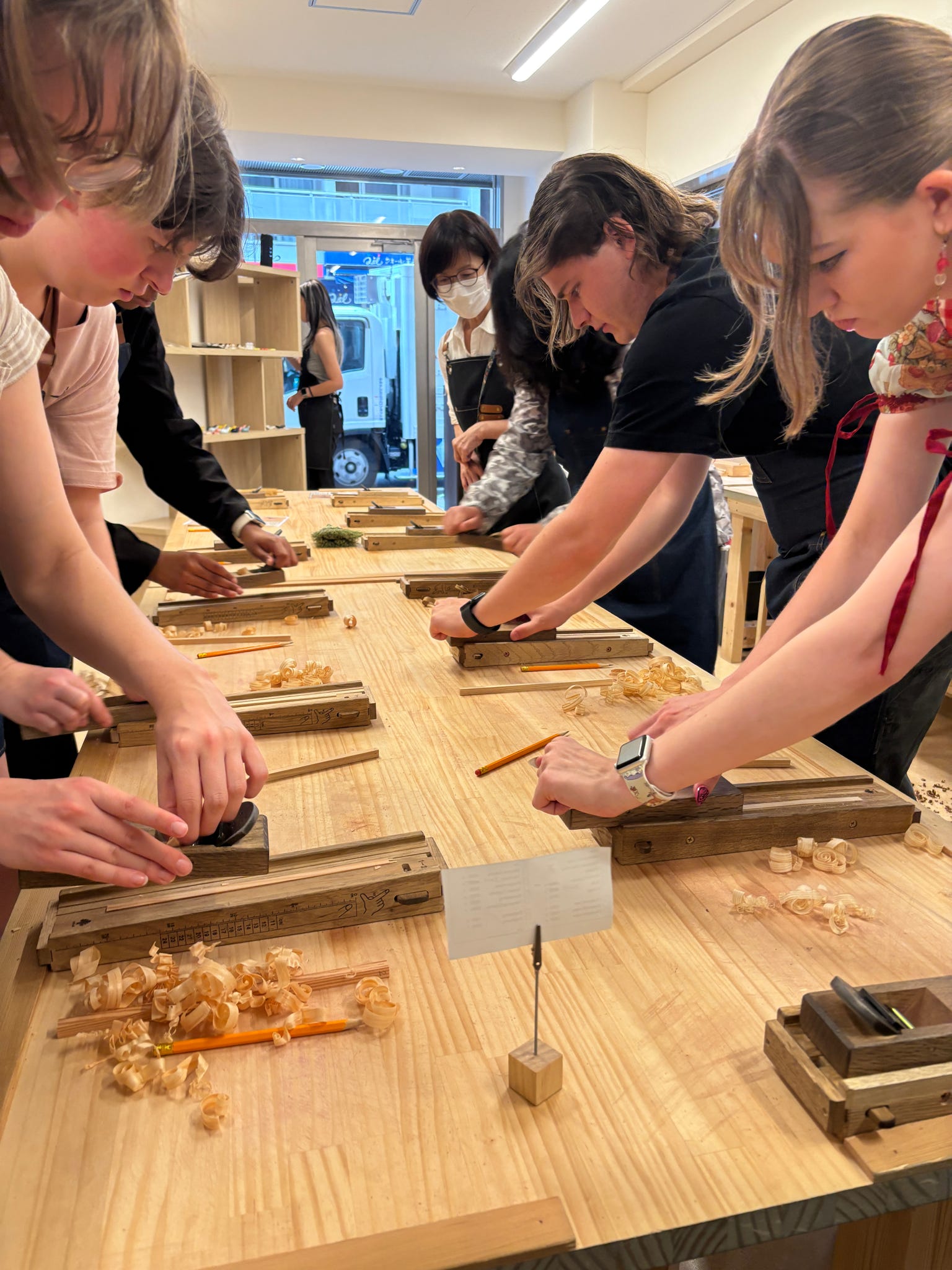 ETSU CBAT and CAS students practice a form of woodworking during the Japan trip.