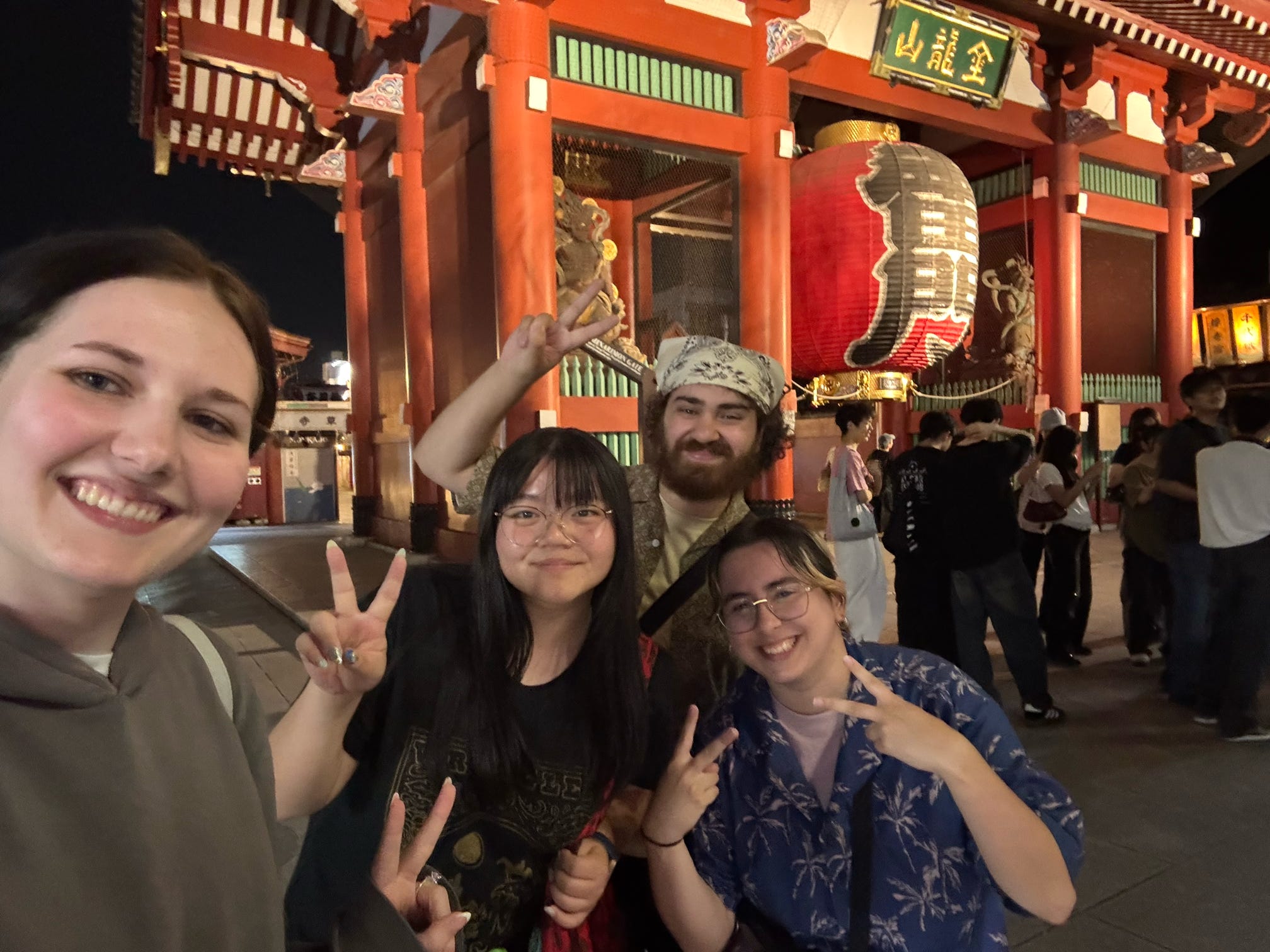 Four ETSU students smile and pose outside during the Japan trip.