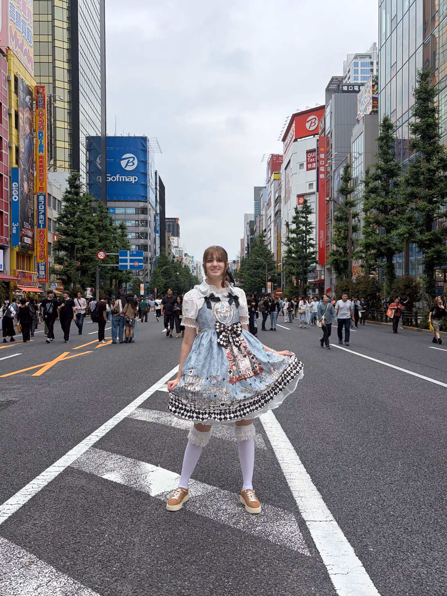 An ETSU digital media student poses on a Japanese street during their trip.