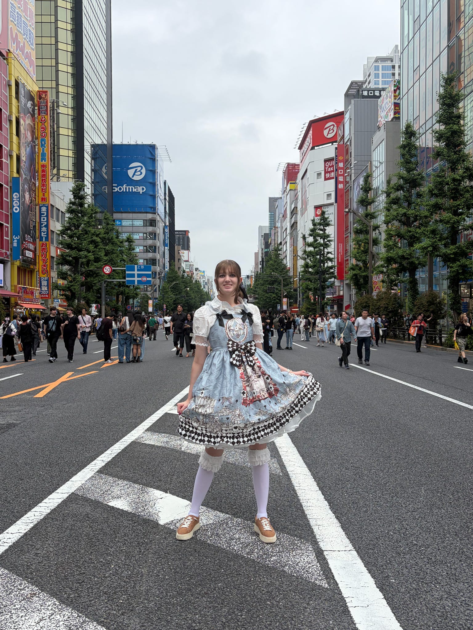 An ETSU digital media student poses on a Japanese street during their trip.