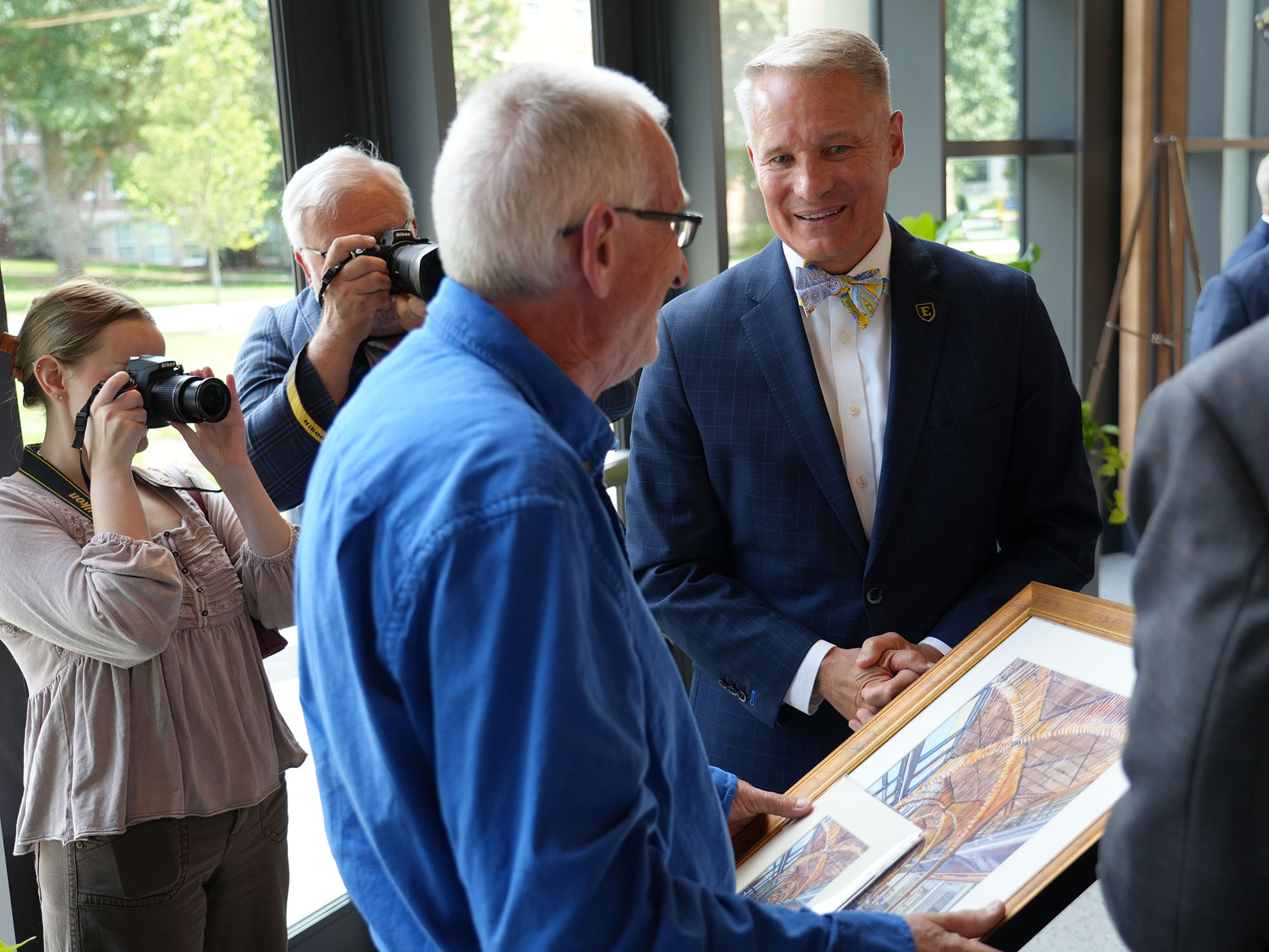 Dr. Noland presents a framed print to Dr. Gordon Anderson.
