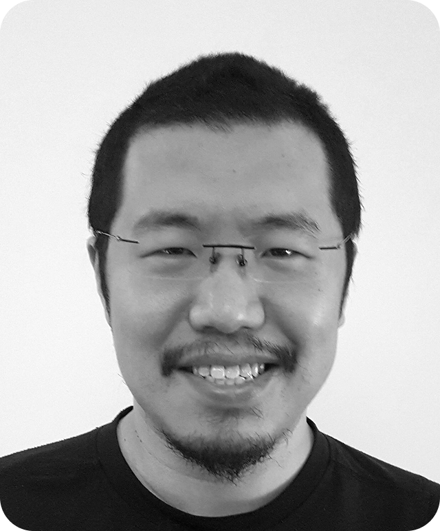 Black and white head and shoulders image of Yan Cui looking at the camera with a smile