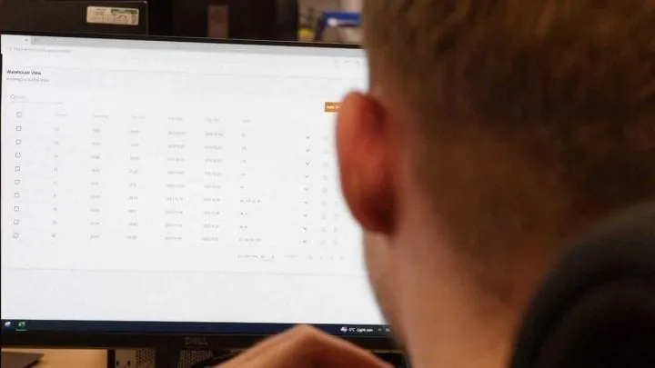Warehouse Manager viewing inventory data from drone