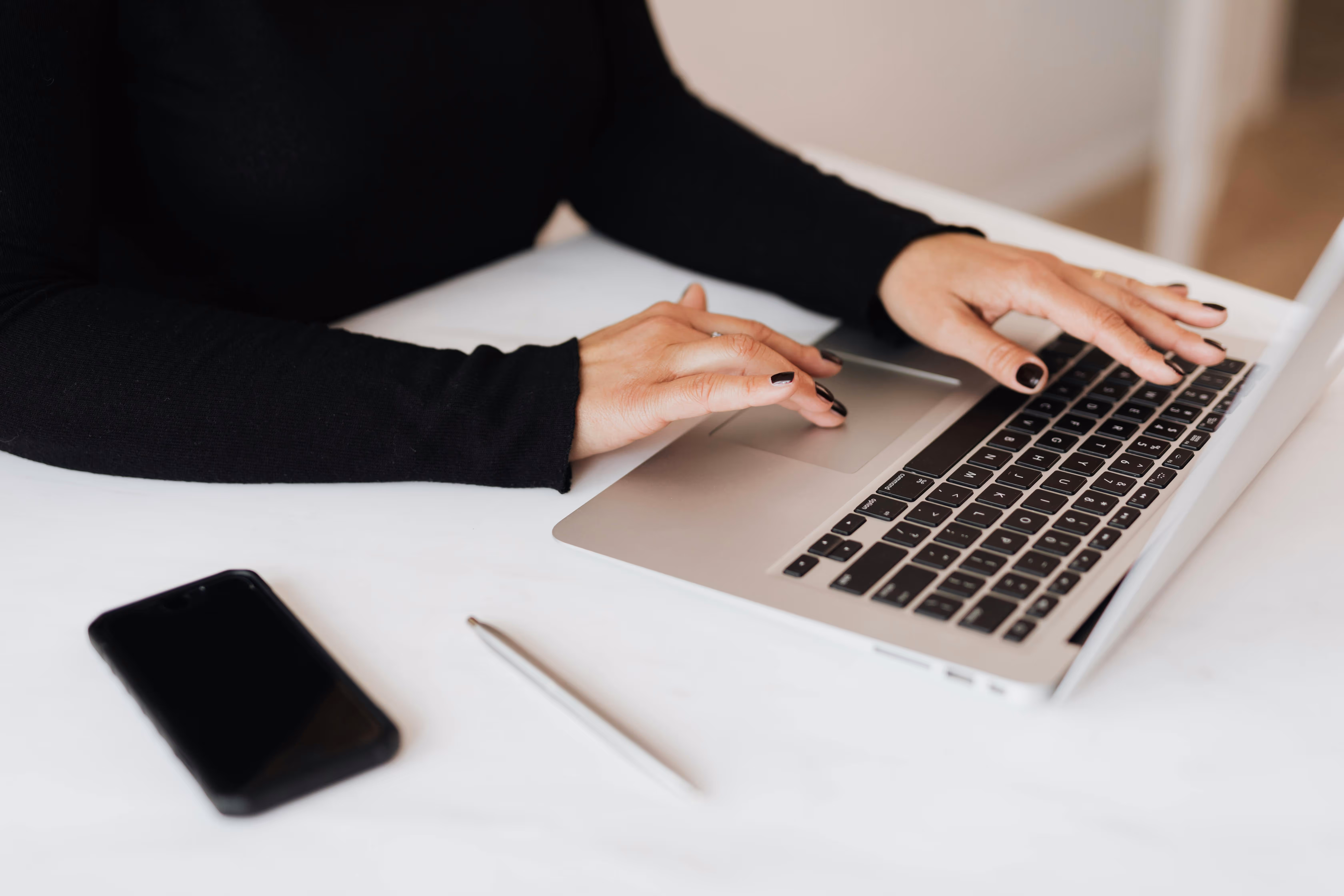 A friendly illustration of a woman on a video call, sitting at a desk with a laptop and holding a mug, representing the relaxed and collaborative free consultation.