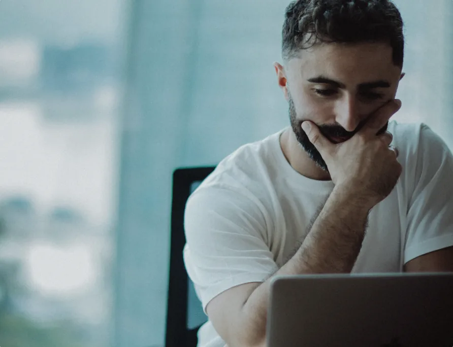 Designer thinking over a laptop