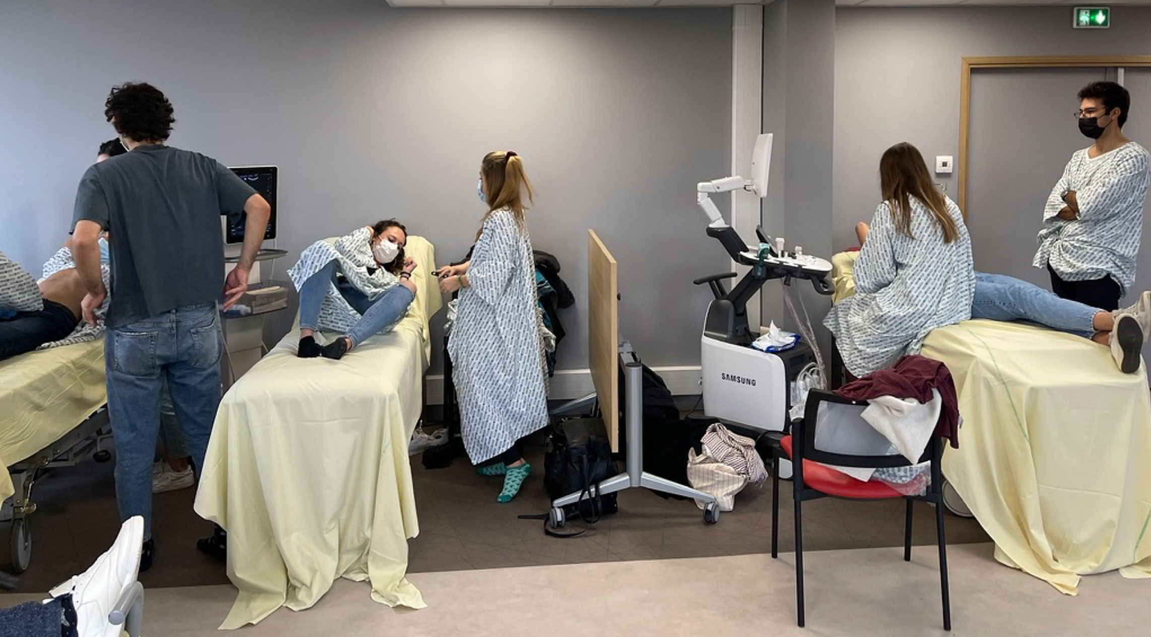 A close-up of a doctor wearing a white coat holding a syringe and a small vial, preparing an injection.