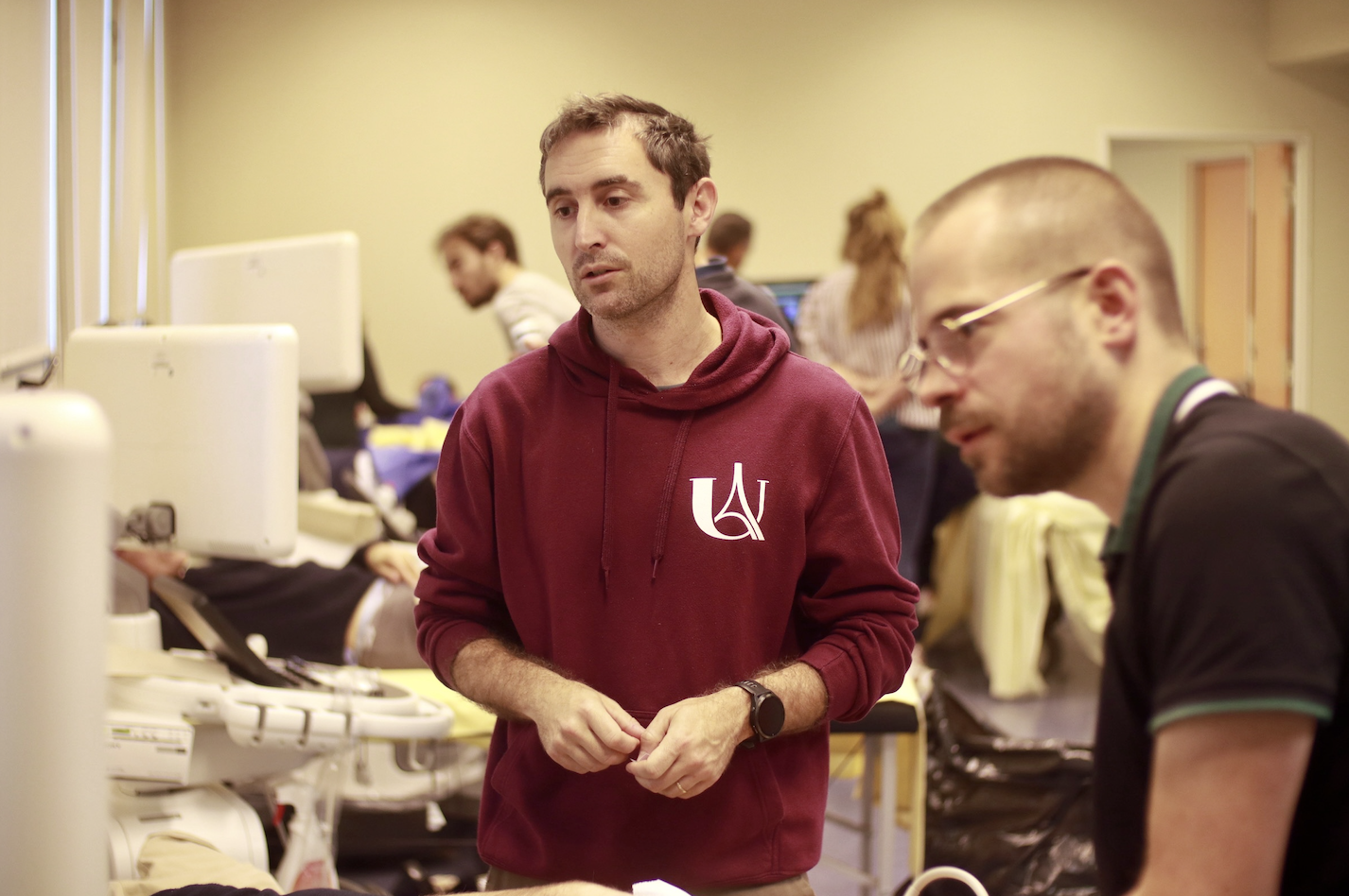 A close-up of a doctor wearing a white coat holding a syringe and a small vial, preparing an injection.