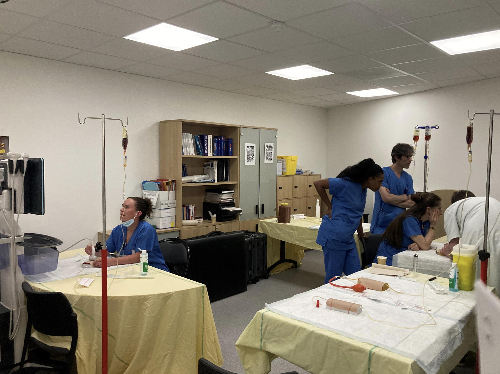 Doctor in a white coat using a tablet in a medical office.