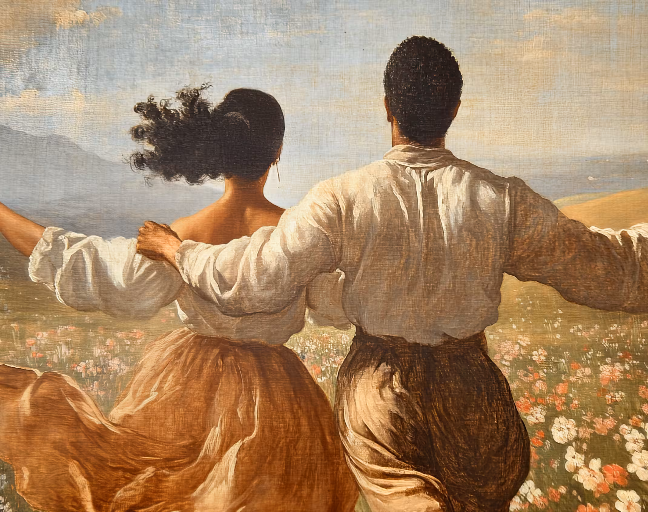 Couple enjoying the in the open field full of flowers