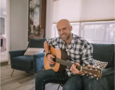 Man showing off his guitar