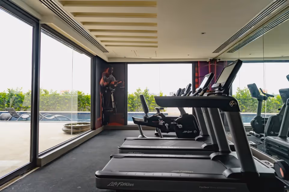Fitness area with panoramic outdoor views and modern workout equipment at Dusit Thani Residence Davao.