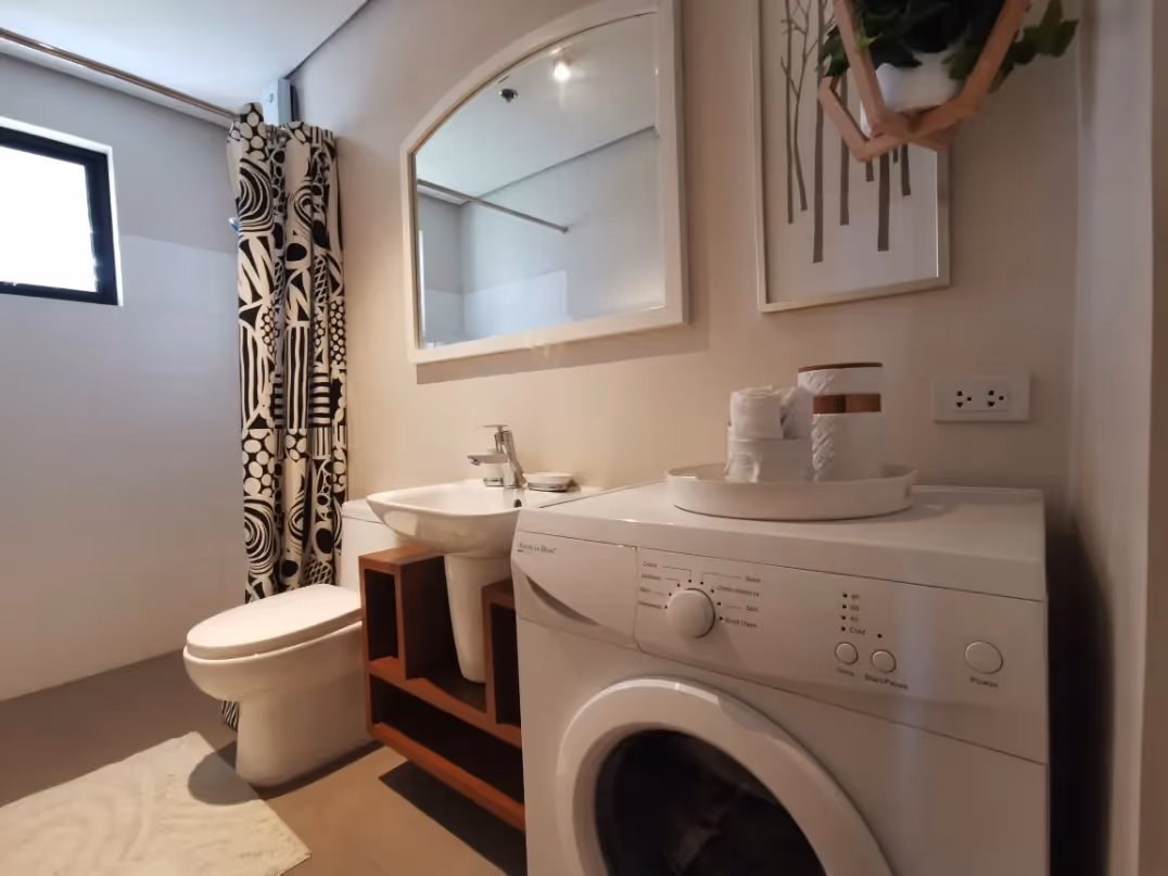 Adria unit bathroom with built-in washer and ample counter space at Adria.