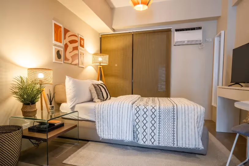 Studio bedroom with warm lighting and minimalist design at Merano, Tierra Lorenzo Lipa.