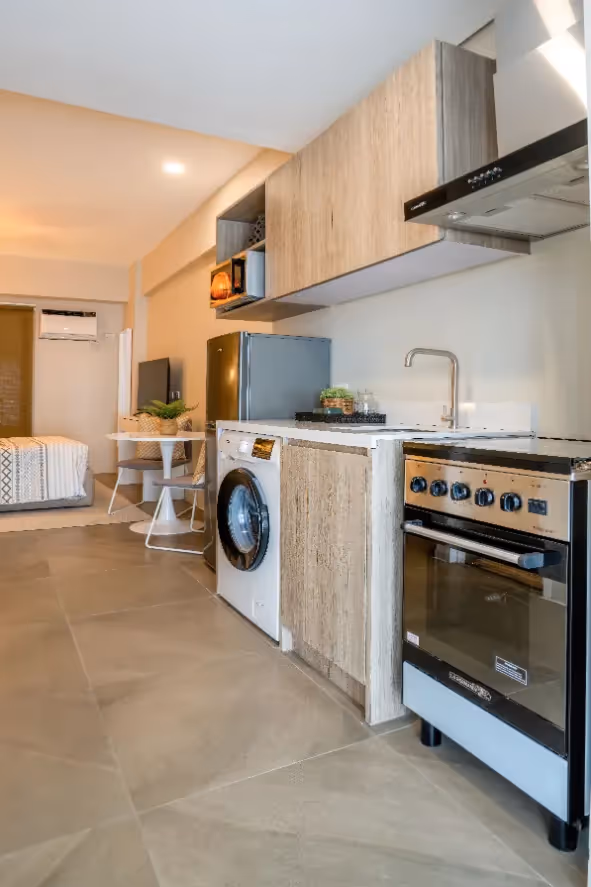Modern kitchen and laundry area combination with efficient layout at Merano, Tierra Lorenzo Lipa.