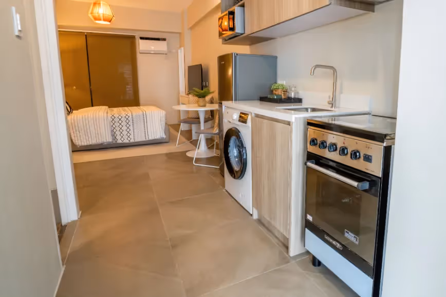 Compact kitchen with built-in stove and overhead cabinets at Merano, Tierra Lorenzo Lipa.