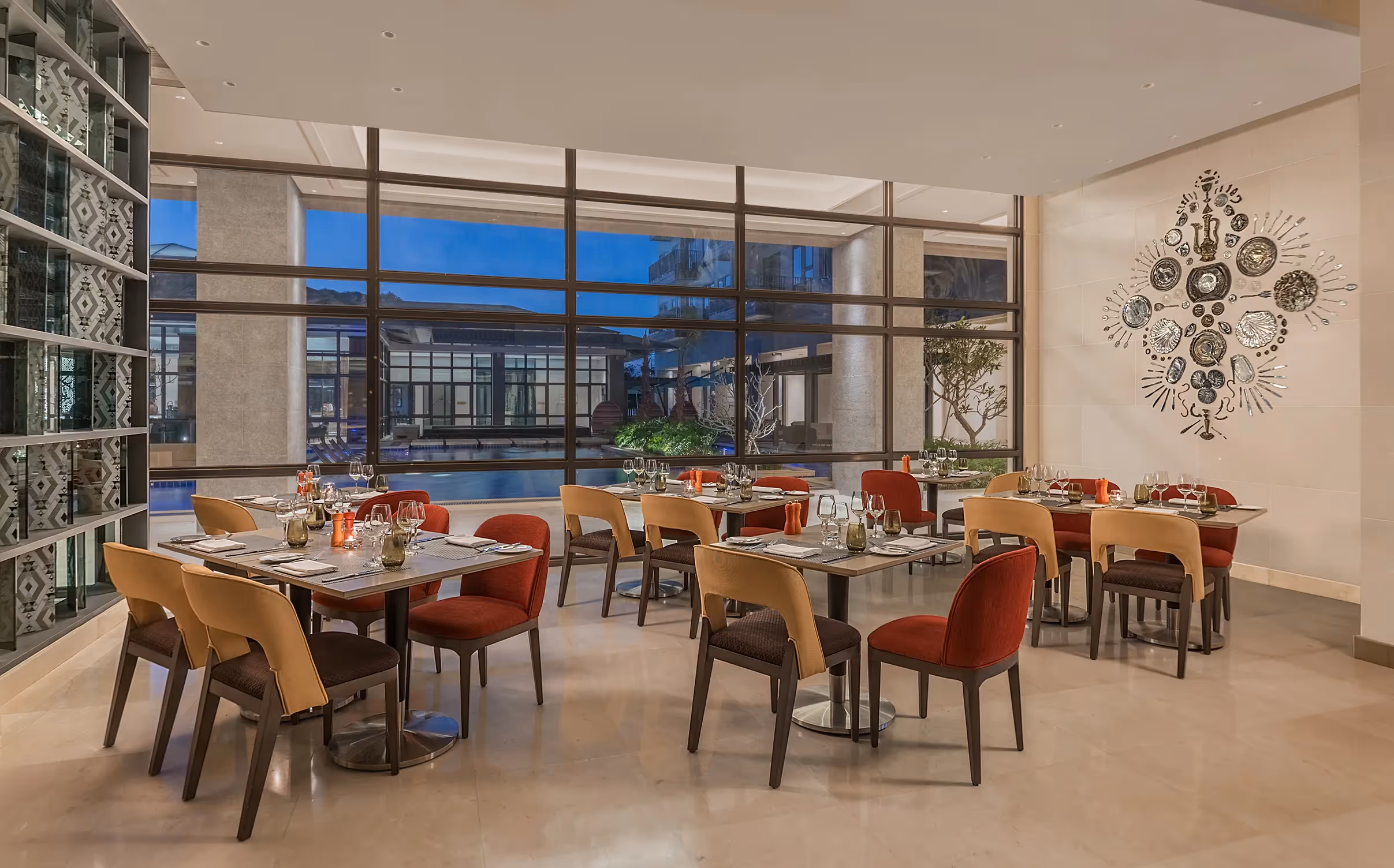 Café-style dining area with floor-to-ceiling windows and cozy seating at dusitD2 Davao.