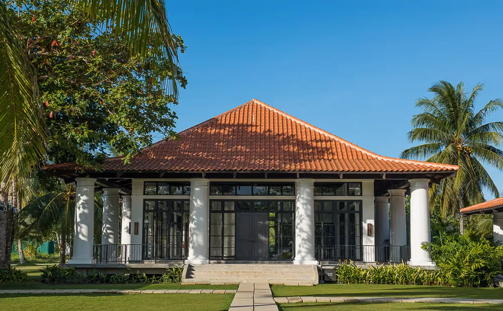 Grand entrance of the main resort with tropical landscaping at Dusit Thani Lubi Plantation Resort.