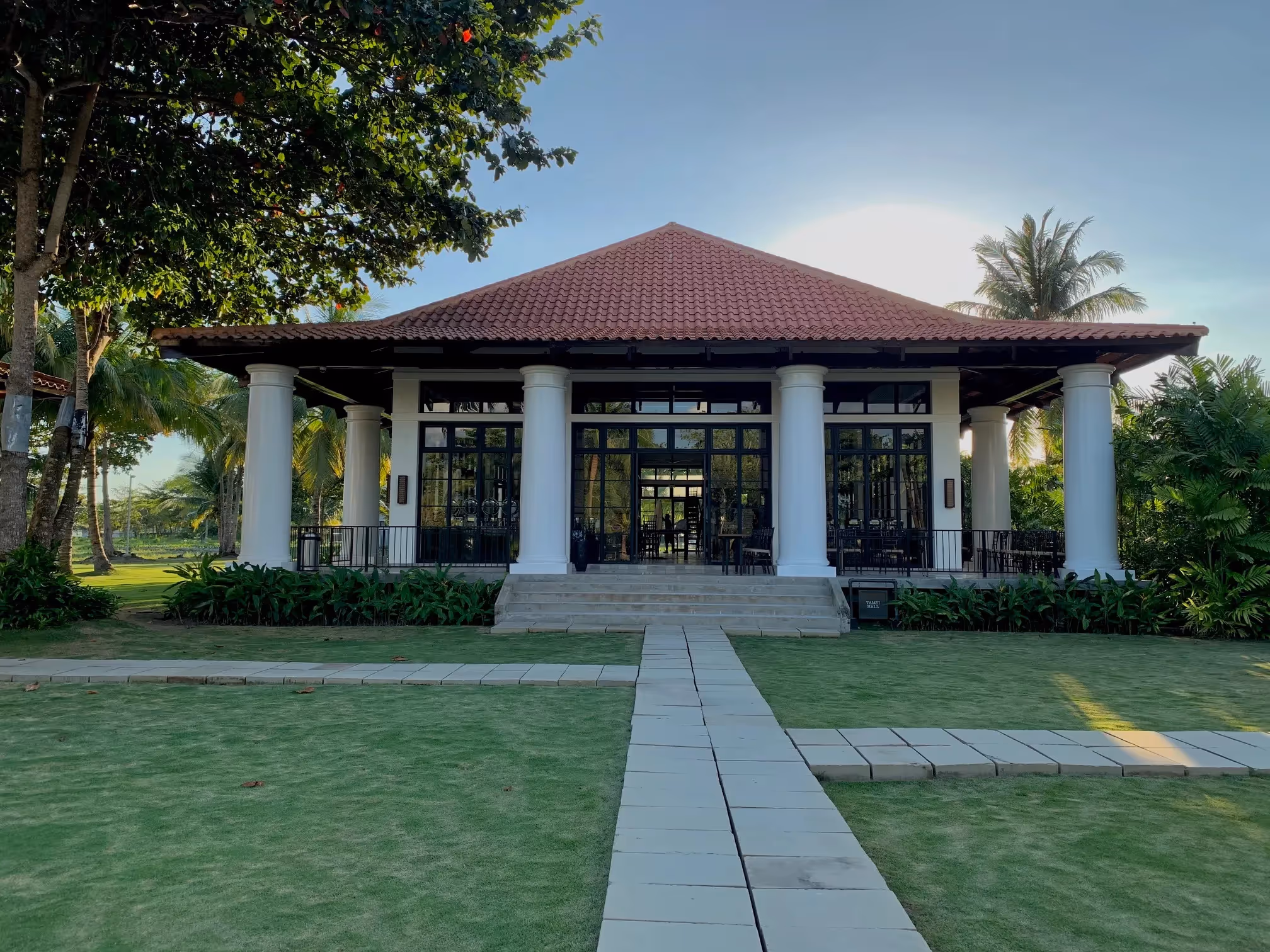 Outdoor restaurant with pool and ocean view at Dusit Thani Lubi Plantation Resort.