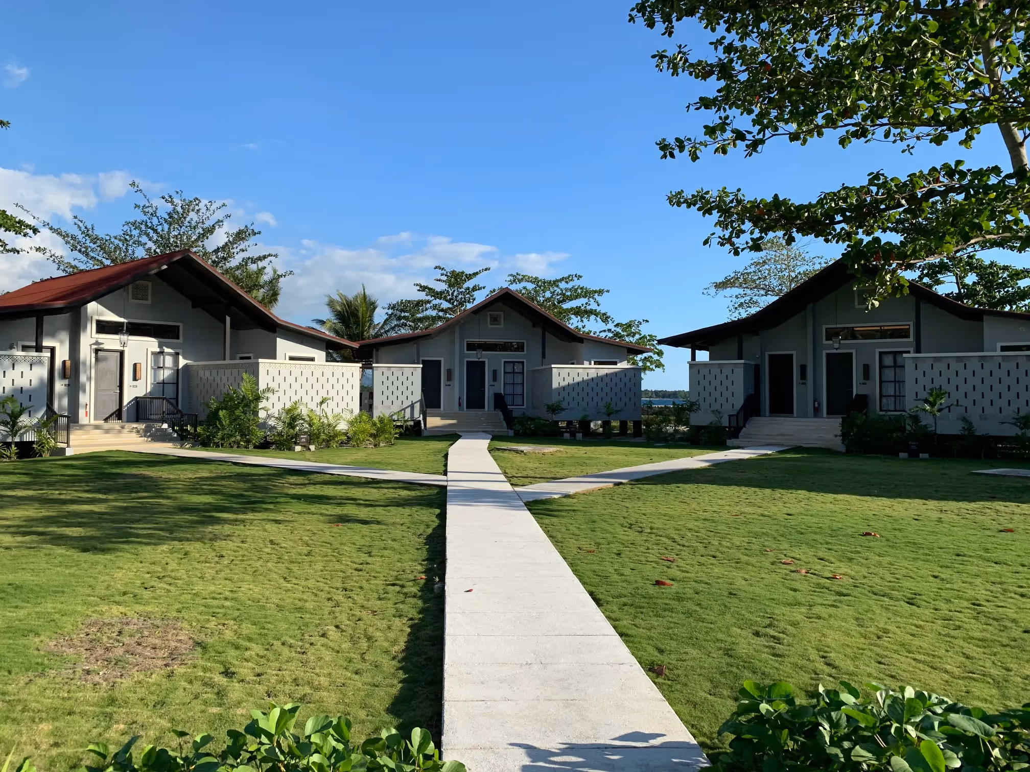 Row of villas along a landscaped stone pathway at Dusit Thani Lubi Plantation Resort.