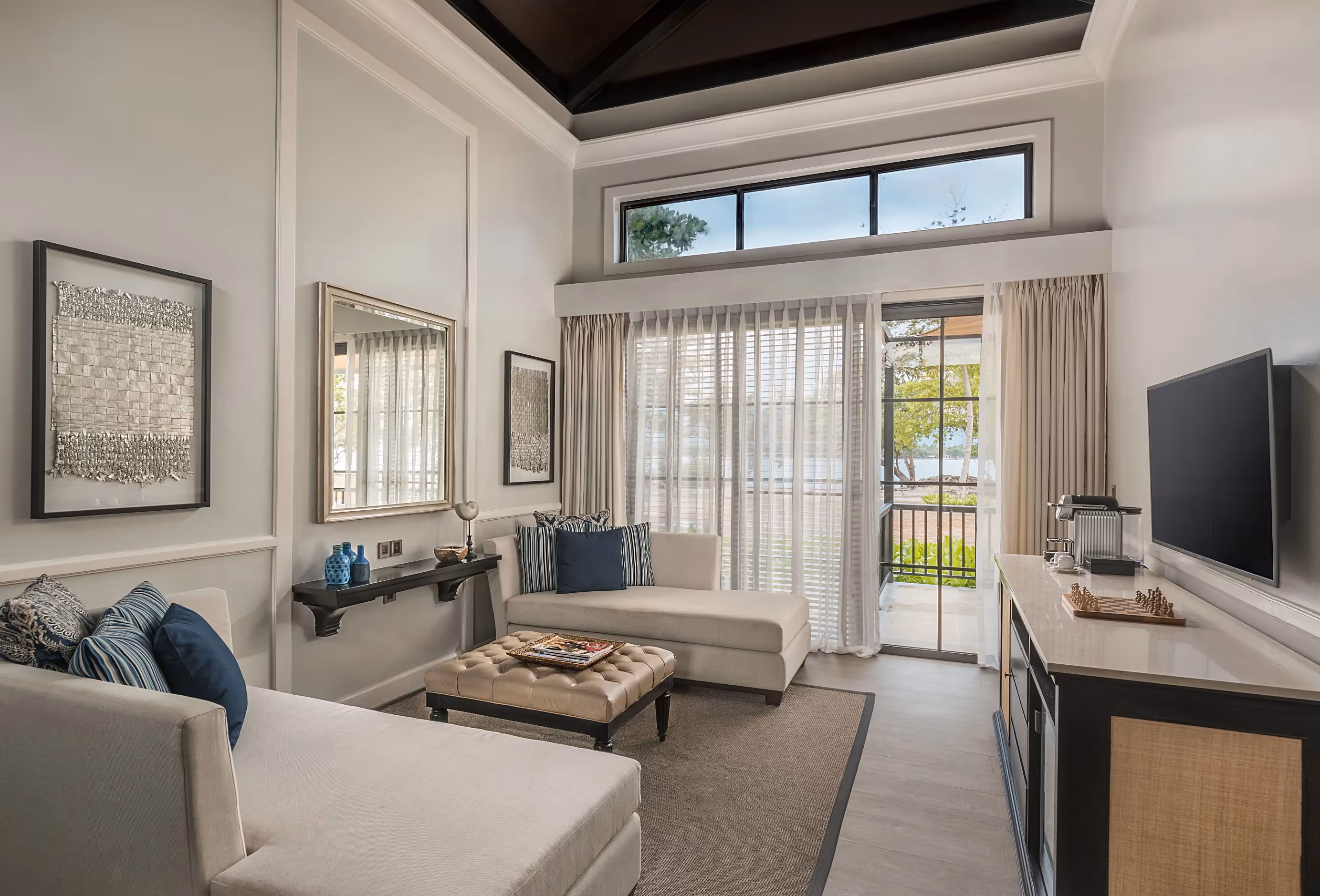 Spacious villa living area with cozy seating and natural light at Dusit Thani Lubi Plantation Resort.