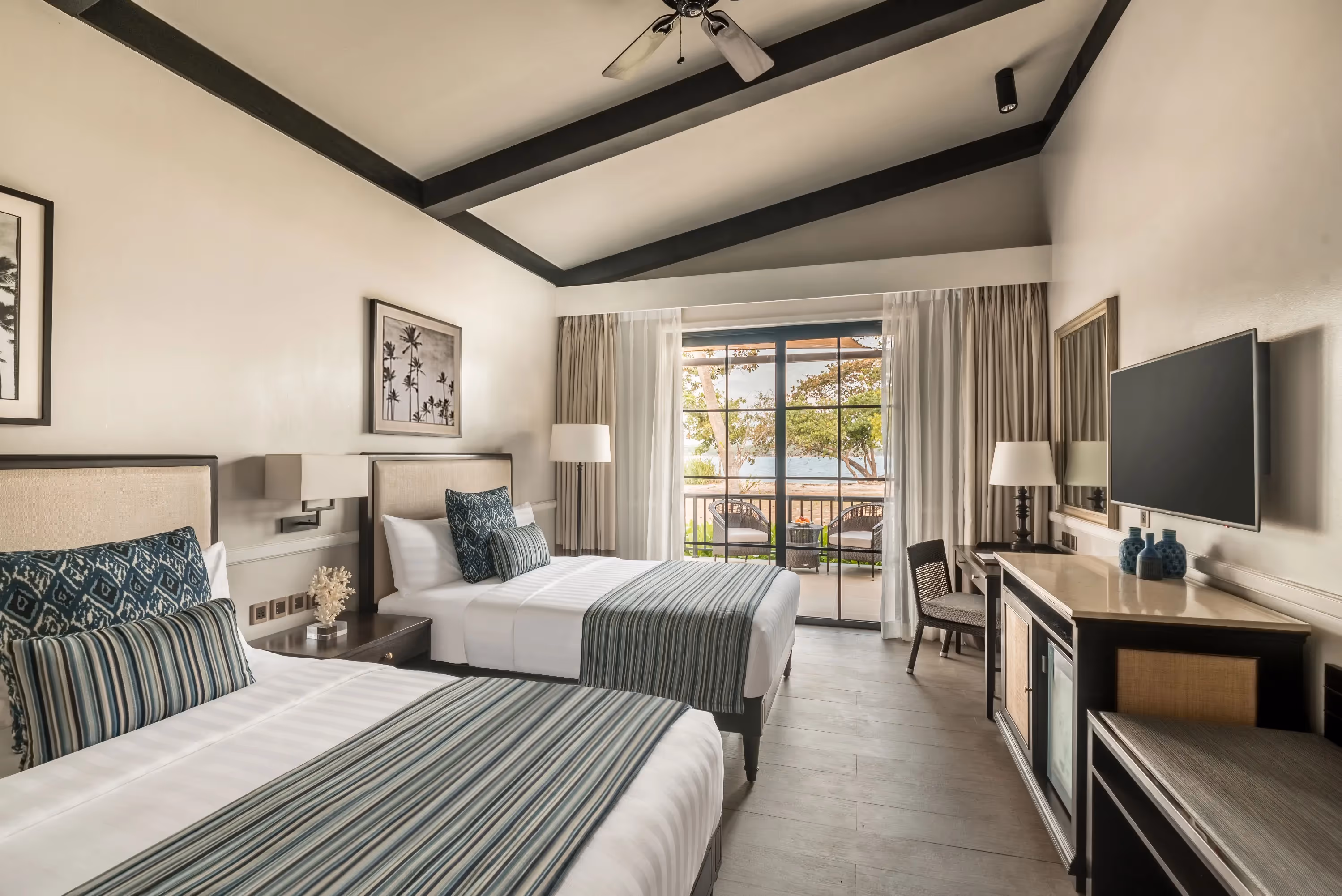 Elegant villa bedroom with stylish furnishings and garden view at Dusit Thani Lubi Plantation Resort.